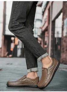 Detail view of brown leather loafer with white hand-stitched seams and non-slip rubber sole