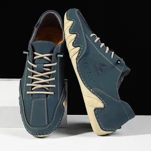Detail of dark teal nubuck leather men shoes with beige wavy sole and Salkin branding