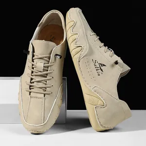 Detail of khaki suede casual men's shoe featuring a wavy rubber sole and Salkin logo