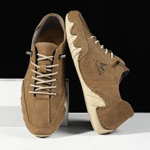 Detail of brown suede casual shoes with Salkin logo and unique wavy rubber sole design