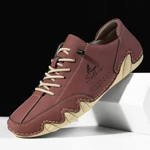 Macro detail of men's burgundy leather casual shoes featuring textured non-slip rubber soles