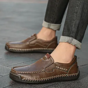 Men's dark brown leather loafers with white hand-stitching and durable rubber sole