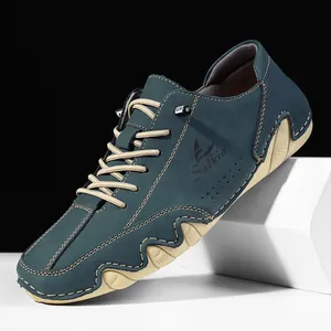 Men's dark teal casual leather shoes with non-slip rubber soles on display stand