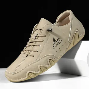 Detail of khaki nubuck leather men's shoe with textured rubber sole and side perforations