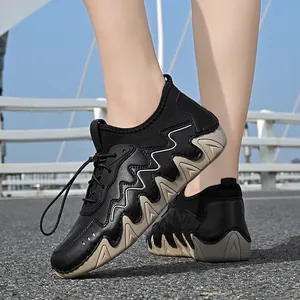 Detail of outdoor walking shoe with wavy rubber sole and quick lace system