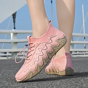 Detailed view of pink leather casual shoe with textured rubber sole and elastic laces