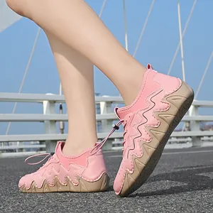Pink outdoor casual shoes with wavy side patterns and drawstring laces shown on foot