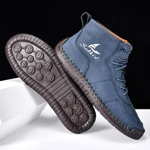 Détails de bottines en daim bleu marine avec semelle antidérapante et broderie latérale