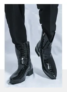 Detail of men's black embossed leather boots featuring a side zipper and pointed toe