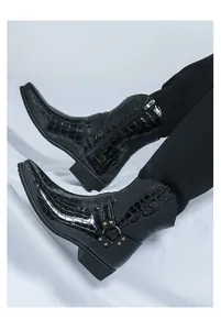 Detail of men's black crocodile embossed patent leather boots with side zipper