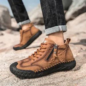 Detail view of brown leather hiking boots with side zipper and durable rubber sole