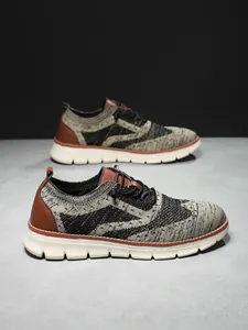Detailed macro view of flyknit mesh texture and leather patches on British style sneakers