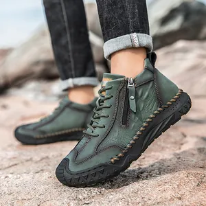 Detail of green alligator texture outdoor boots with side zipper and rugged rubber sole