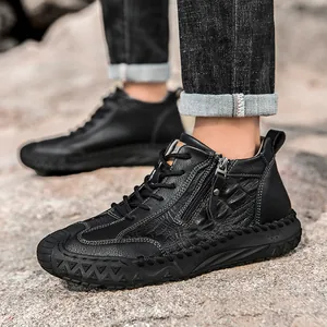 Close-up of black high-top leather shoes with crocodile texture and rugged rubber sole