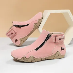Detalle de los botines de ante rosa con cremallera lateral y cierre de tira adhesiva