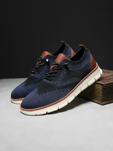 Detail of blue breathable mesh sneakers with brown leather accents and thick white sole