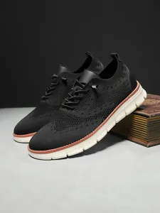 Close-up of men breathable knitted trainers with brogue pattern and dual-tone sole