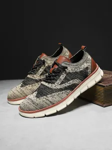 Detail of khaki and black knit mesh upper with brown leather accents on men sneakers