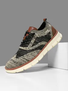 Detail of breathable knitted mesh texture and leather trim on men athletic sneaker