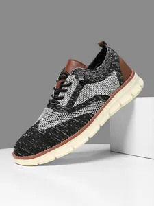 Macro shot of breathable knitted mesh texture and leather accents on men's sport shoes
