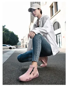 Detailed macro view of pink suede boots with side zipper and wave texture rubber sole