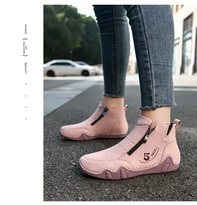Close-up of pink casual ankle boots with side zipper and wave pattern non-slip sole