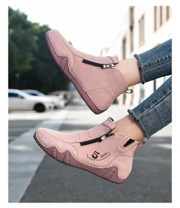 Pink suede flat ankle boots featuring side zipper and decorative numerical prints