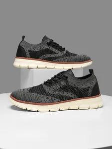 Macro shot of breathable knit mesh fabric and textured chunky sole on grey men's sneakers