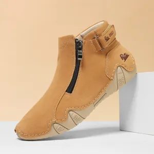 Detalle de botas de ante marrón claro con cremallera lateral y suela de goma gruesa