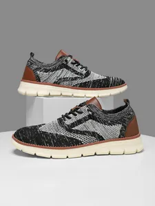 Close-up of knit camouflage upper and thick anti-slip sole on men's running sneakers