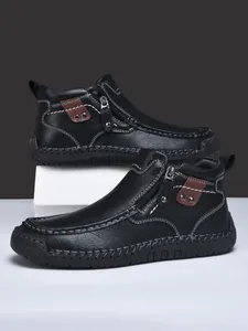 Dettaglio stivali casual in pelle da uomo con borchie e chiusura a zip laterale