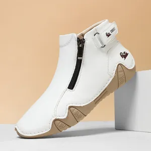 Detalle de botas de cuero blanco con cremallera negra y suela de goma antideslizante