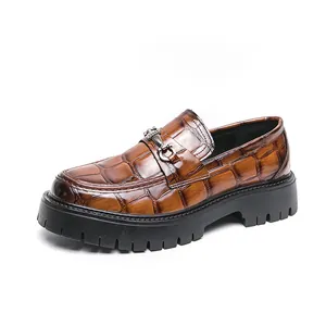 Dettaglio mocassino marrone in pelle coccodrillo con fibbia vintage e suola spessa