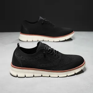 British style black knit running shoes with thick cream soles and brown welt details