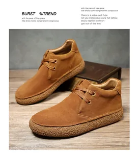 Detail of tan suede desert boots featuring textured rubber soles and two-eyelet lacing