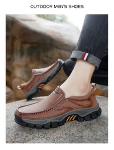 Detailed view of durable non-slip rubber soles on brown leather outdoor hiking shoes