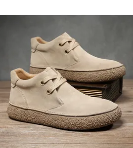 Close-up of beige suede men's martin boots with thick brown textured rubber soles