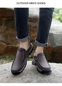 Brown outdoor casual men's shoes with slip-on design and thick rubber sole on rocky terrain
