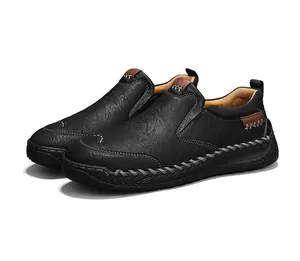 Détails de coutures faites main et texture de cuir litchi sur mocassins noirs pour hommes