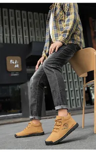 Detailed view of men's brown suede outdoor casual shoes with stylish side logo and laces