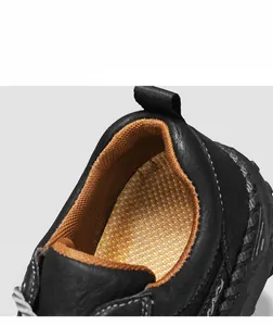 Detail of soft breathable brown mesh lining and handmade stitching on black leather shoes