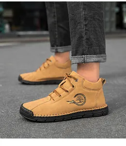 Outdoor view of men's khaki high-top casual boots with thick rubber soles and side logo