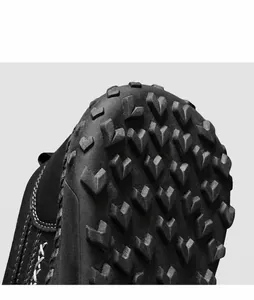 Macro view of flexible rubber sole with anti-slip texture and durable white hand stitching
