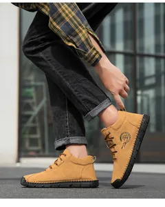 Close-up of ginger nubuck leather boots featuring contrast hand stitching and rugged black soles