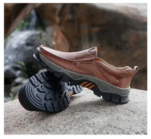 Detail of brown leather men's shoe showing stitching, perforations and non-slip rubber sole