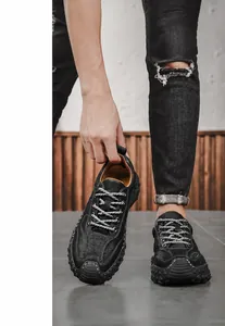Detail of black pebbled leather men's loafers featuring textured non-slip rubber soles