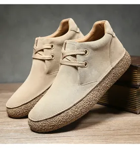 Close-up of tan suede leather finish and textured rubber sole on casual desert boots