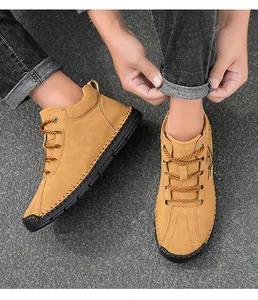 Macro view of khaki suede men's boot with hand-stitched detailing and rugged rubber sole