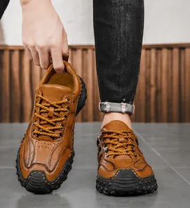 Detail of hand-stitched hollow brown leather loafers for men with durable rubber sole