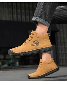 Detail view of ginger men's leather boots with hand-stitched soles and side zipper